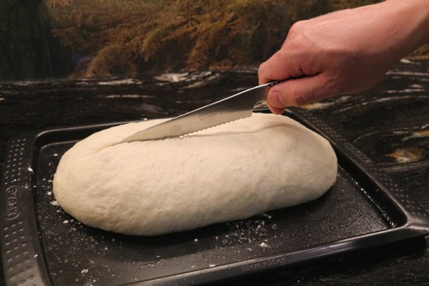Score the centre of the dough quickly with a very sharp knife ...