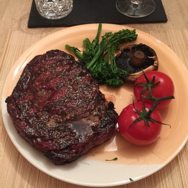 Rib-eye steaks served with roasted vegetables
