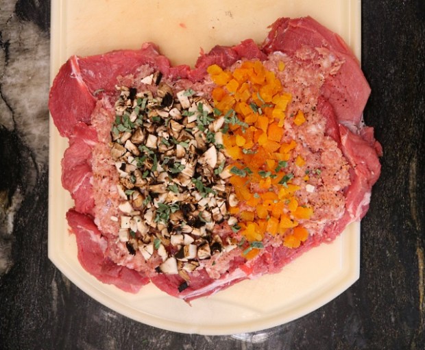 Ingredients layered onto the pork before rolling