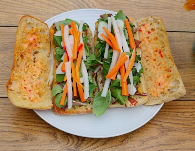 Banh mi ingredients layered onto the two paninis