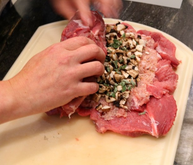 Roll the pork shoulder into a log shape ...