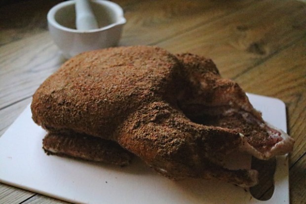 Duck rubbed and ready to be wrapped, excess is brushed off before cooking