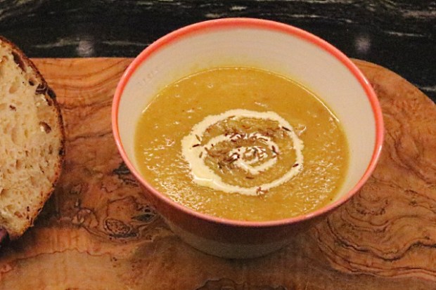 Spicy roast parsnip soup served with some crusty homemade bread