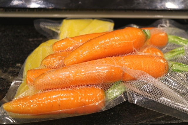 Carrots vacuum sealed with frozen cubes of orange juice