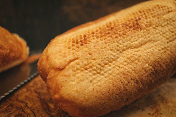 Dimples on the base of a baguette from a perforated proving tray