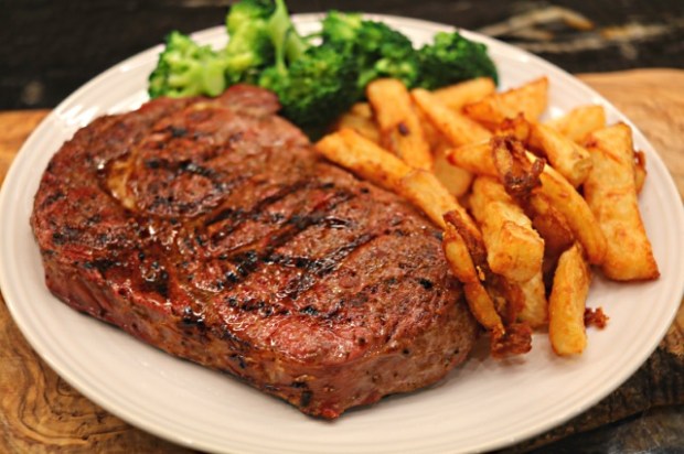 Sous vide rib-eye steak with triple cooked chips and broccoli