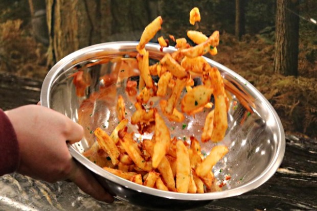 Tossing the chips in a salad bowl with oil and parsley