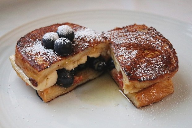 Banana and blueberry French toast dusted with icing sugar