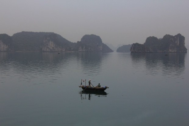 A fishing boat in the early morning mists of Halong Bay
