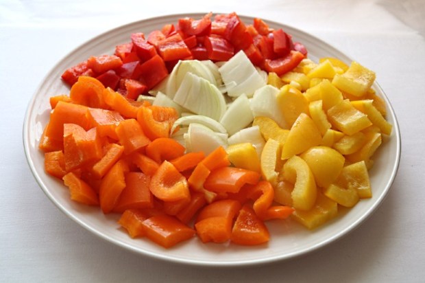 Red, yellow and orange peppers with onion ready for stir fry