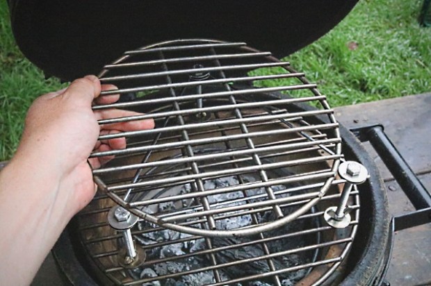 The top grid being lifted off without taking the bolts with it