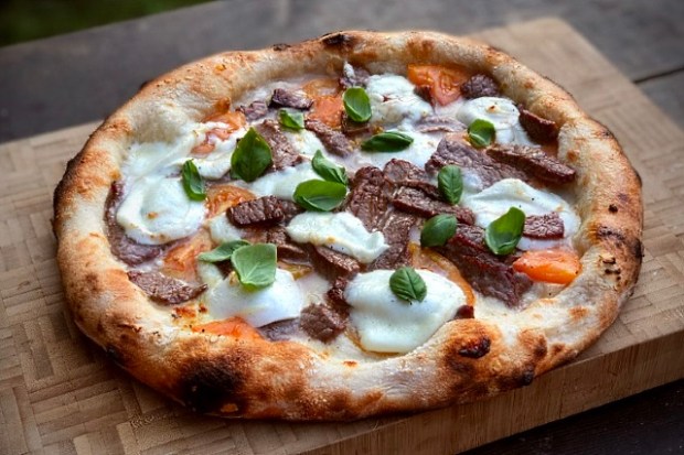 Triple buffalo pizza cooked and ready to slice