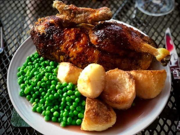 Duck a l'orange served with roast potatoes and vegetables