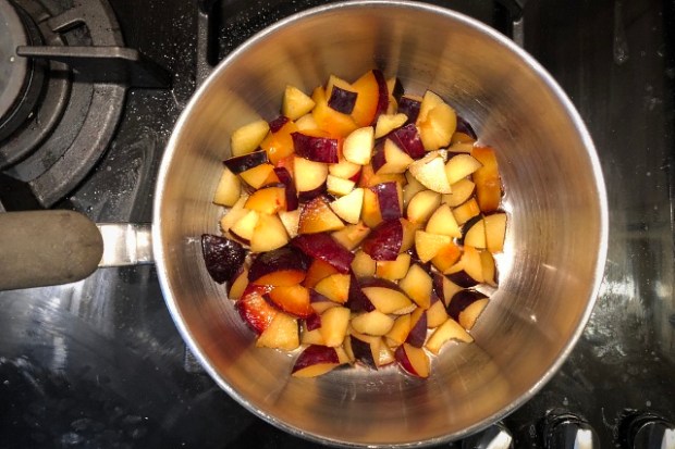 Plums steaming in a saucepan