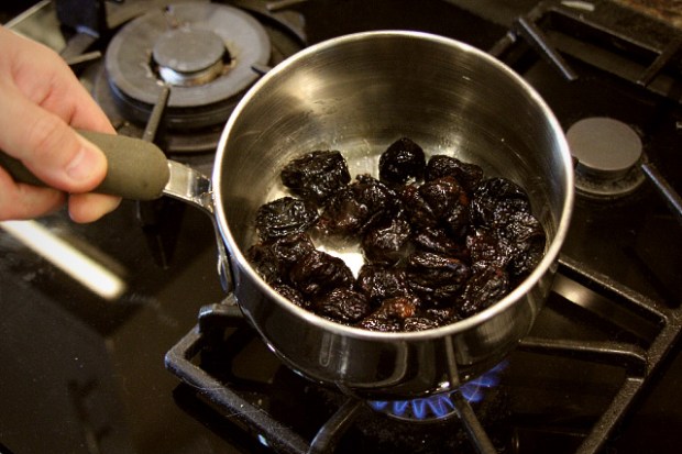 Heating prunes in rum to infuse the flavours