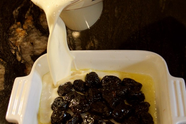 Pouring batter over the prunes