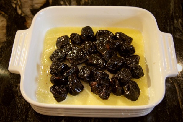 Prunes arranged in the middle of the baking tray